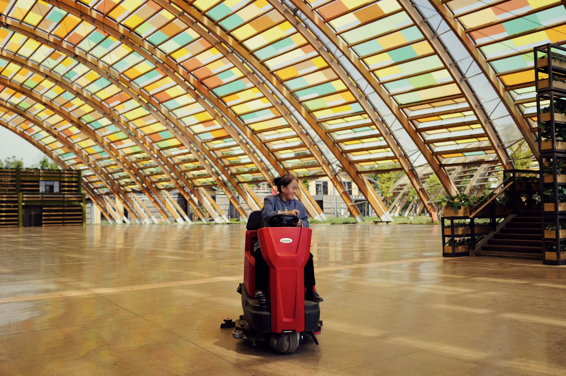 Worker using floor scrubber after construction