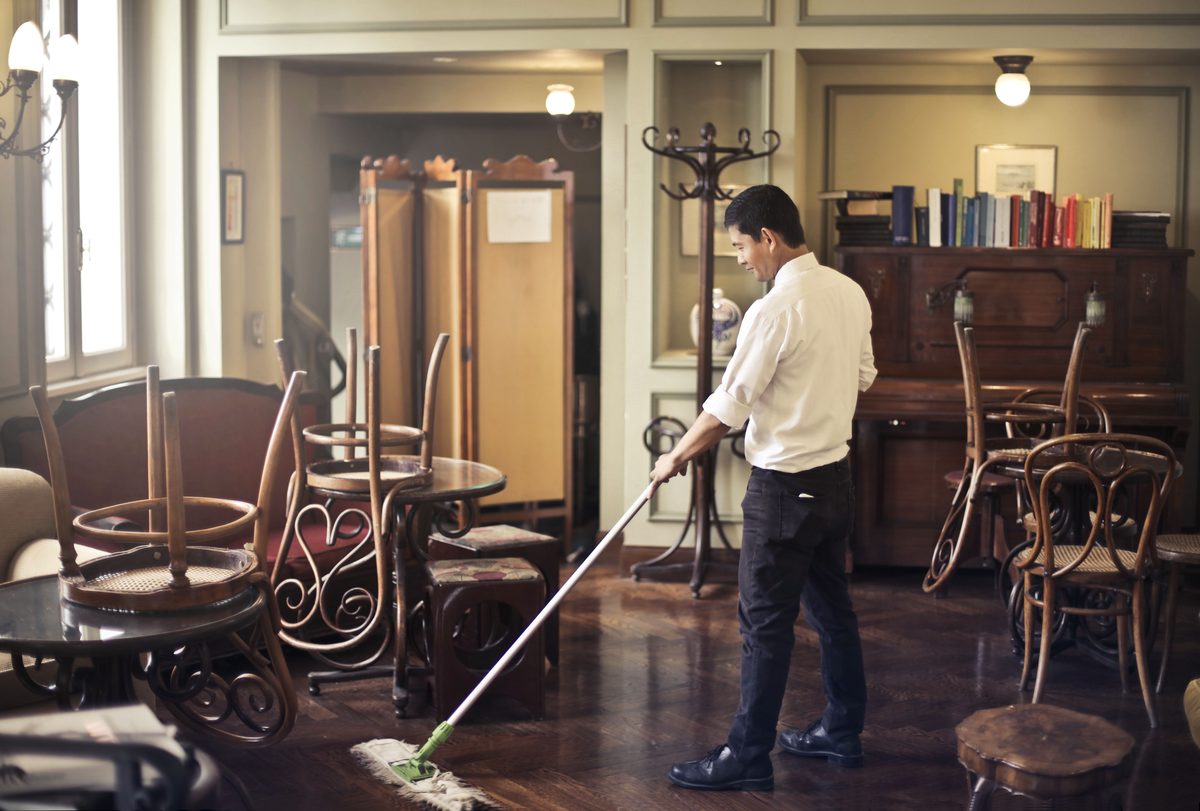 Worker mopping floor during final cleanup