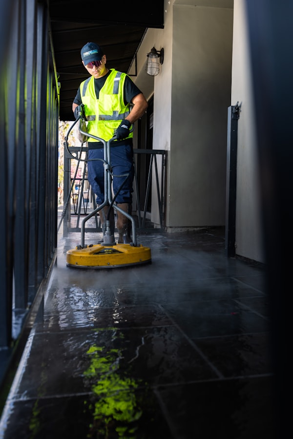 Worker cleaning floor after construction